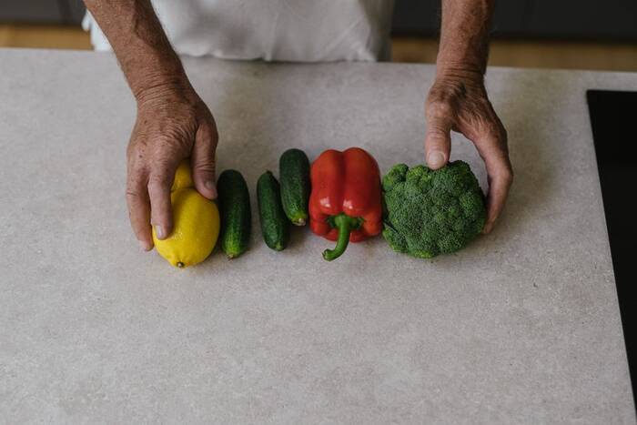 A person selecting fresh vegetables in the kitchen